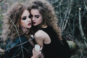 Two vintage witches gathered eve of Halloween photo