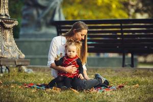 Mother and little daughter playing in a park photo