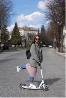 Young girl posing on a scooter photo