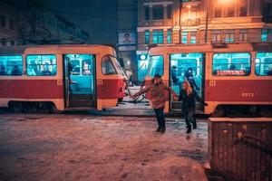 Young adult couple on snow covered tram station photo