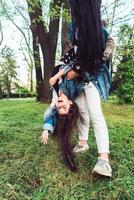 mom and daughter on the lawn have fun photo