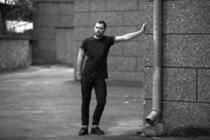 The man in the authentic boots and selvedge jeans  on a background of old city photo