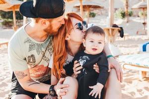 Parents spend time with their son on the beach photo