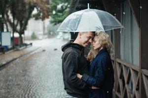 Couple on the street with umbrella photo