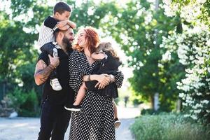 Mom, Dad, little son and daughter have fun photo