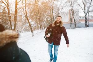 Young couple having fun on the snow photo