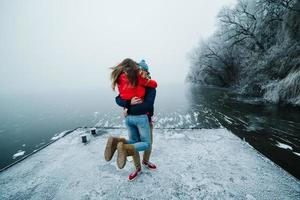 beautiful couple having fun on the pier photo