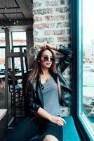 Beautiful girl in sunglasses posing on camera photo