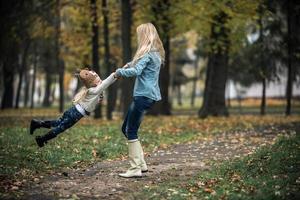 Mother with daughter in autumn park photo