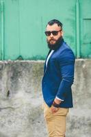 Stylish bearded man walks through the city photo