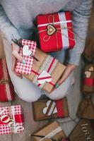 A lot of gifts on Valentine's Day in the hands of a girl photo