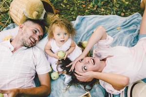 Father, mother and daughter in the park photo