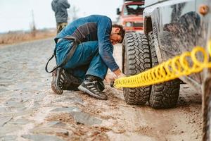 A man pumps air wheel with a compressor photo