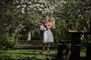 mother twist daughter in the garden photo