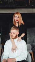 A young woman and her boyfriend are posing for the camera indoors. photo