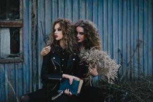 Two vintage witches gathered eve of Halloween photo