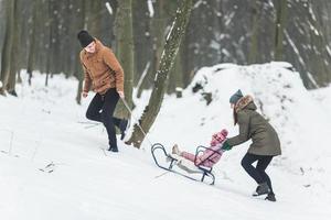 Dad and Mom with a little daughter in the park photo