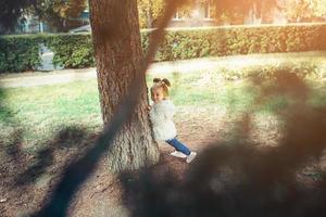 Cute little girl is playing outdoors photo