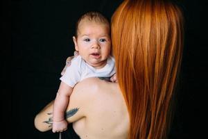 Young mother woman holding her child baby photo