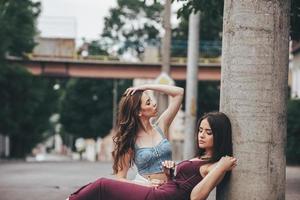 Two beautiful young girls posing in the city photo