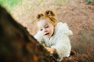 Cute little girl is playing outdoors photo