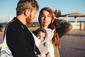 Happy joyful young family in summer park photo