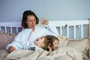 Mom and her two little cute daughters are having fun photo