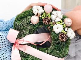 Young woman holding a Christmas wreath photo