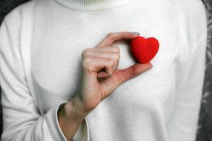 Girl holding a small lovely heart photo