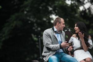 Young European couple cuddling on a park bench photo