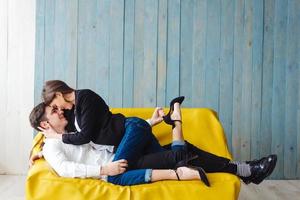 guy and girl on a yellow couch photo