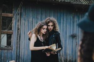 Two vintage witches gathered eve of Halloween photo