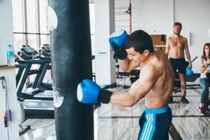 Boxer with punching bag in gym photo