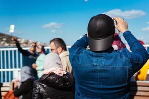 Man in black cap taking pictures of birds photo