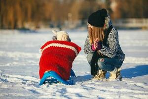 mother and daughter in winter outdoors photo
