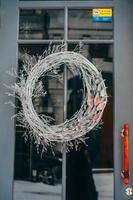 Christmas wreath hanging on the glass door in cafe photo