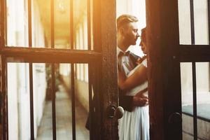 Groom and gorgeous brine in hotel room photo