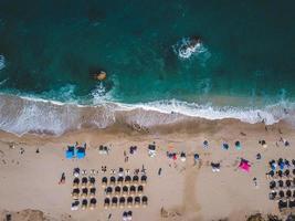 Beach with sun loungers on the coast of the ocean photo