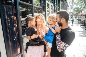 beautiful young family with ice cream photo