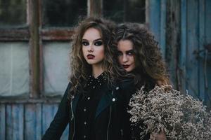 Two vintage witches gathered eve of Halloween photo