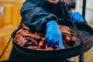 Two tier grill with delicious spiral sausages photo