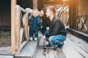 Mom dad and little son together on the street photo