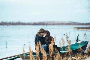 young beautiful couple on the ice of a frozen lake photo