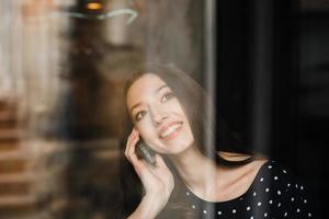 Beautiful girl talking on the phone and smiling photo