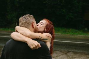 beautiful couple kissing  in the rain photo