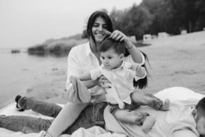 Happy young family relaxing together on the lake photo