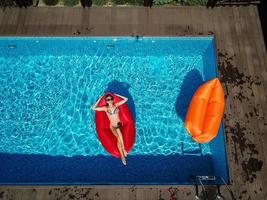 One girl is swimming in the pool photo