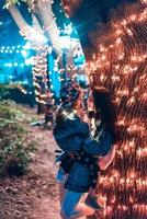 mom kisses her daughter in the evening park photo