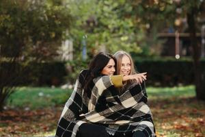 two beautiful in the park, posing for the camera photo