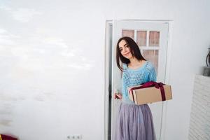 Woman holding Christmas gift box in her hands photo